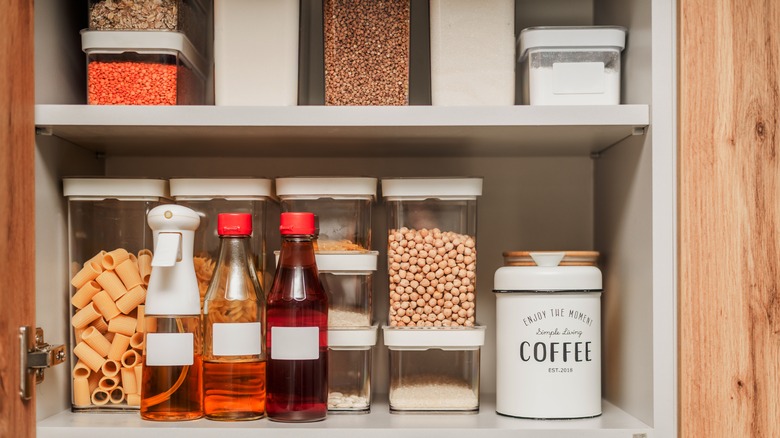 Organized kitchen pantry with foods in containers