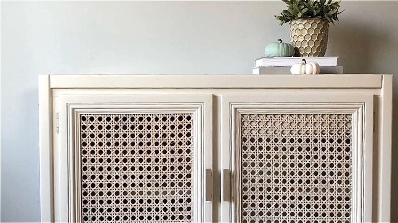 A close up on a headboard with cane webbing.