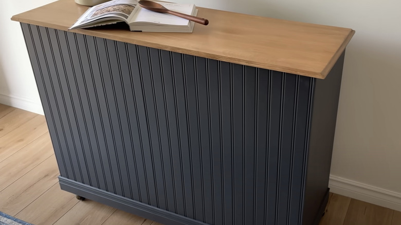 A small prep table with a solid wood surface.