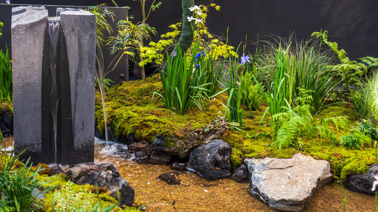 A tall standalone fountain with two waterfalls in garden