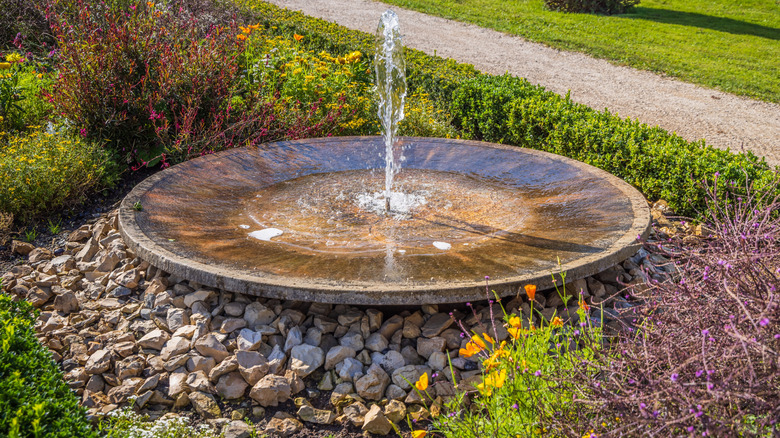 A plate fountain with a single spout of water