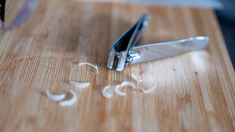 Nail clippings near a nail cutter on a table