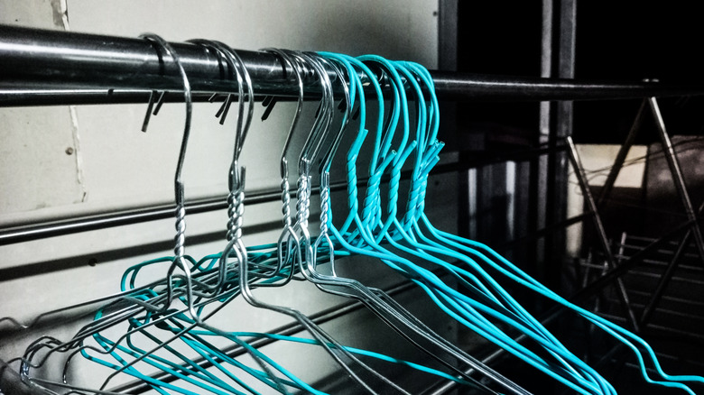 Empty wire hanger hanging on a metal rod