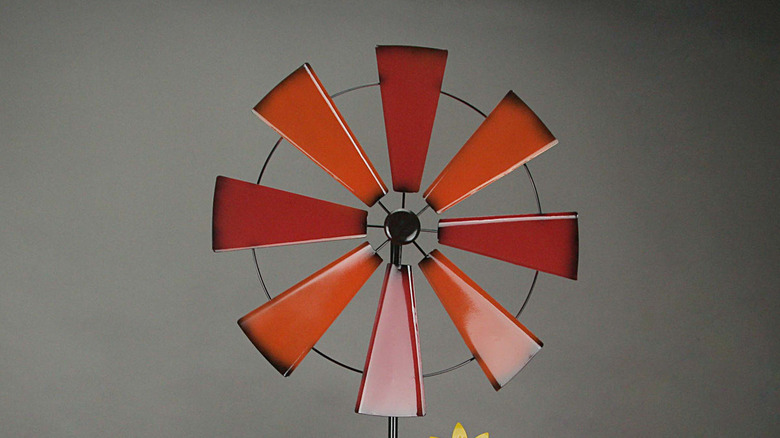 A red and orange windmill against a gray background