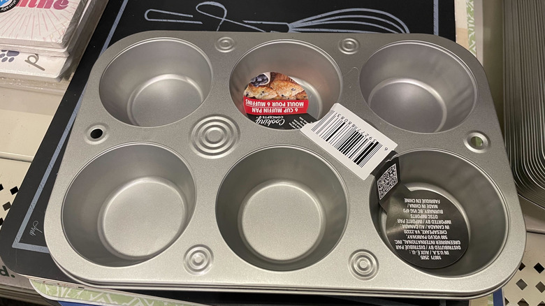 A 6-cup metal muffin tin on the shelf in a Dollar Tree store.