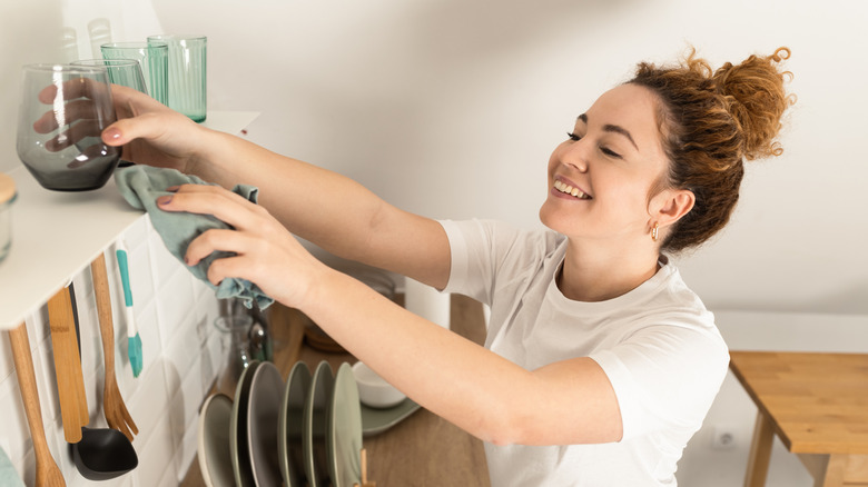 A woman tidies up a kitchen