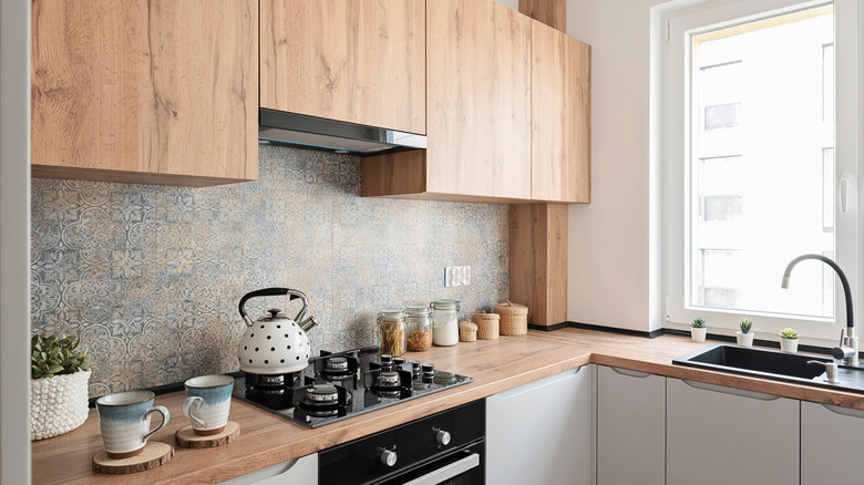 Modern stove drip pans in a wood kitchen