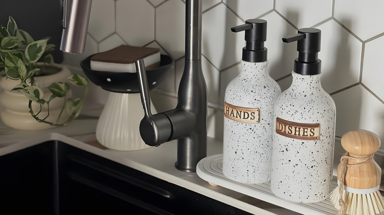 Stylish soap pumps by a faucet