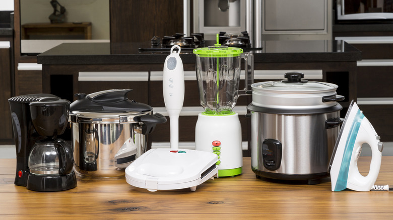 A range of small kitchen appliances sitting on a kitchen counter.