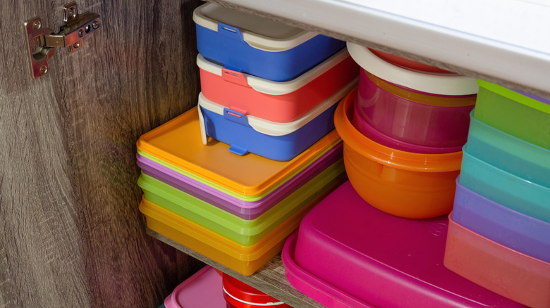 Stacks of coloured food storage containers.