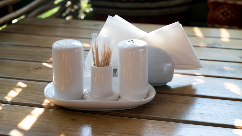 pink salt and pepper shakers on porcelain tray