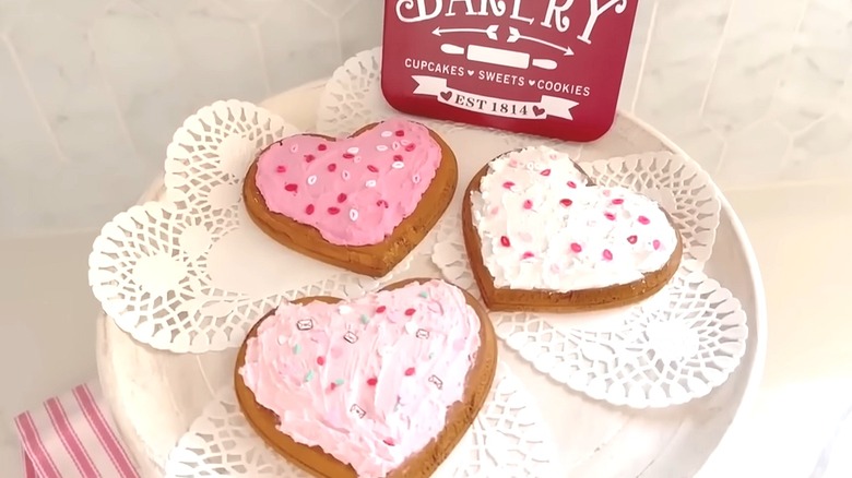 Wooden hearts topped with spackle and sprinkles to replicate the look of Valentine's cookies