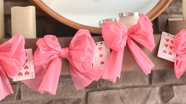 Section of a garland on a mantel made from Dollar Tree tablecloths and playing cards