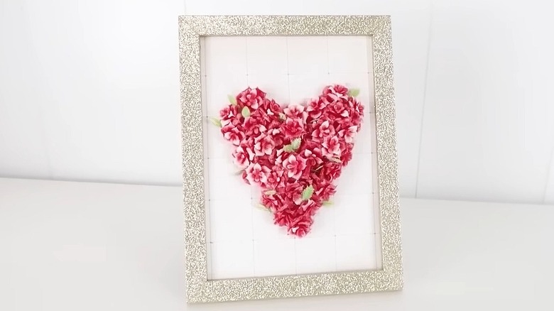 Framed Valentine's Day art with a floral heart in the center of a glittery frame from Dollar Tree