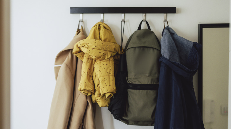 Coats hanging on a wall-mounted coat rack