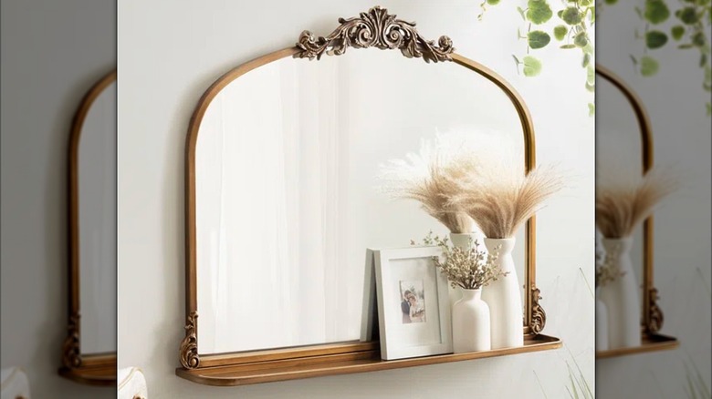 Mirror and ledge combo hanging on a wall