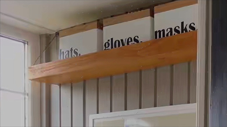 Floating shelf hung high on a shiplap wall