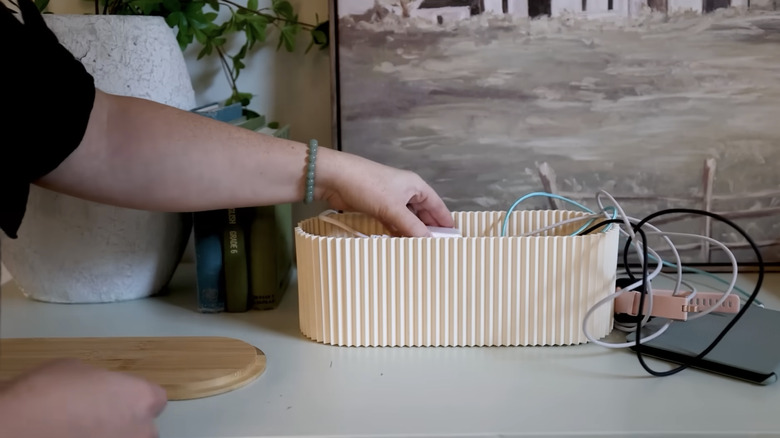 hand putting cords in box