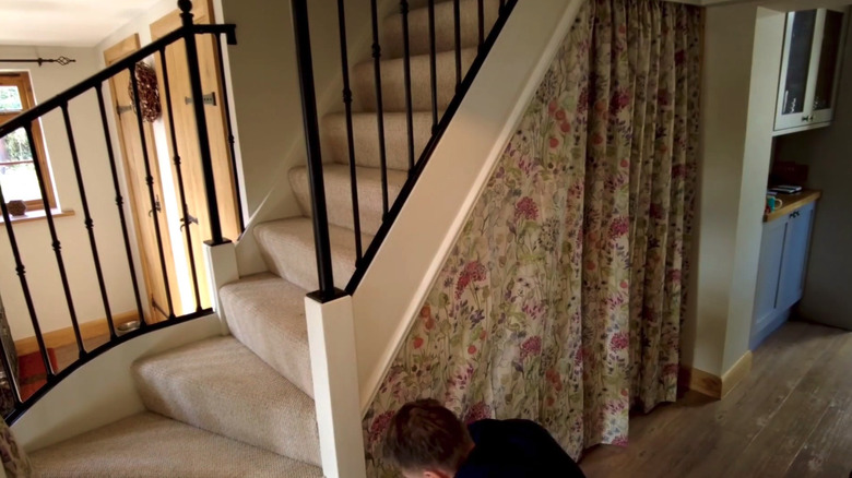 hanging curtain over under-the-stair storage