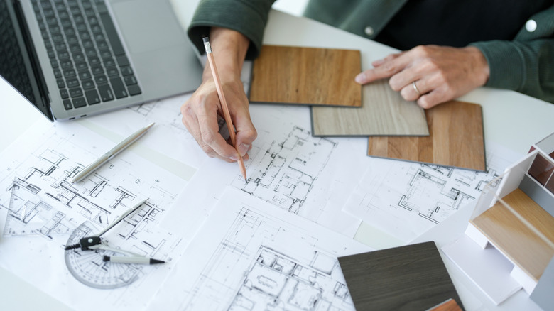 A person draws up plans for a new home design