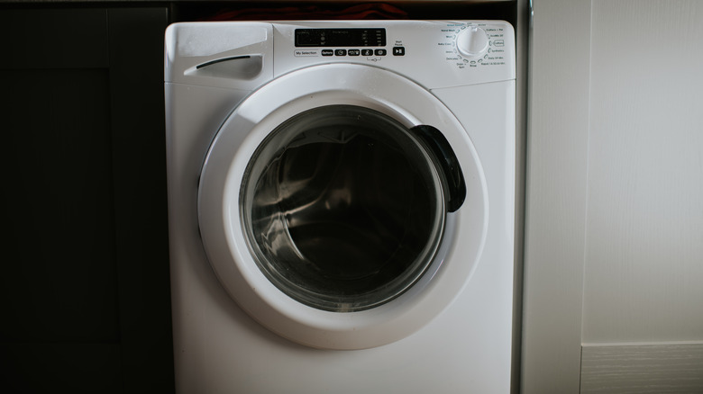 Closeup of a white front-loading washing machine