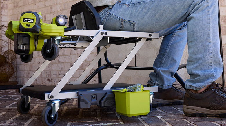 a person uses a Ryobi lighted creeper seat