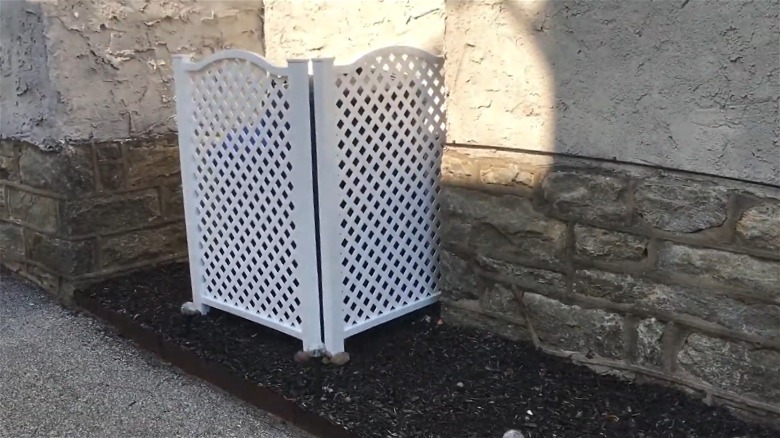 Premade panels creating a two-sided outdoor cover for trash cans