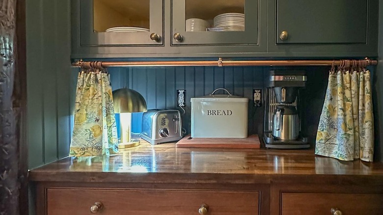 DIY appliance garage made by hanging short curtains below an upper cabinet