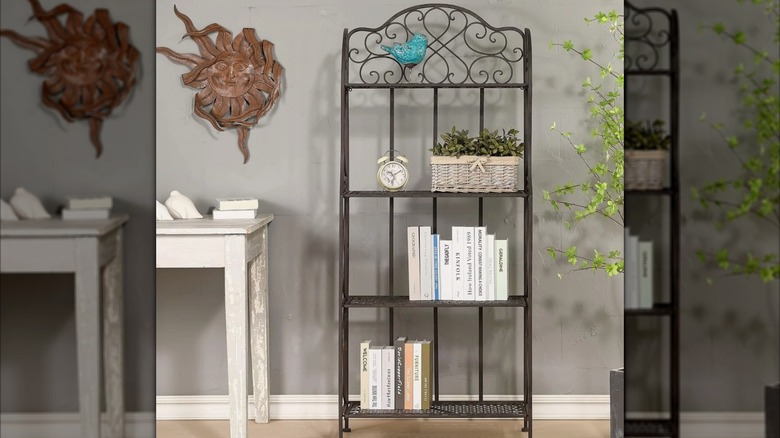 Four-tired antique bronze bakers rack with cookbooks, plants and home decore items