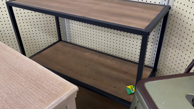 Black and brown bakers rack on a shelf at hobby lobby surrounded by other on sale items