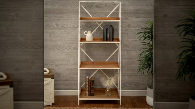four-tiered white and brown ladder shelf with decorative home items and potted plants