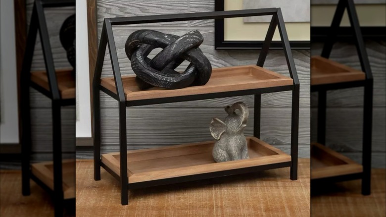 two-tiered shelf on a counter with smal home decore items on it