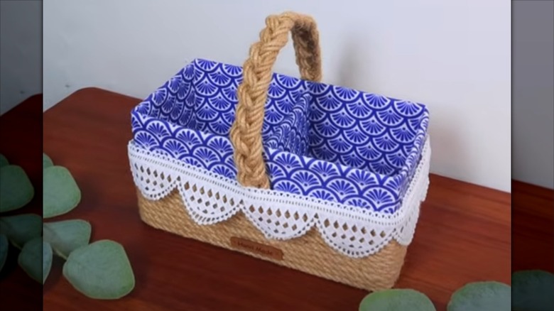 A divided decorative basket made from a shoe box
