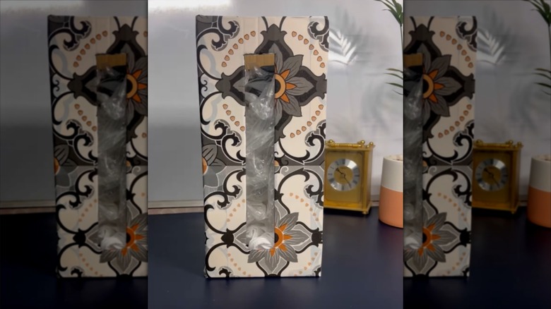 A plastic bag dispenser made from an old box