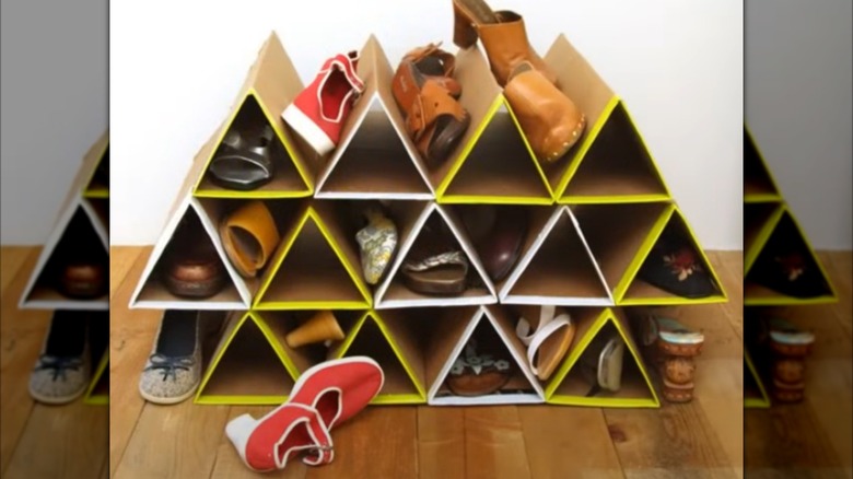 A simple shoe shelf made of cardboard triangles