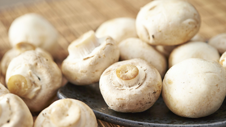 closeup of white button mushrooms in bowl