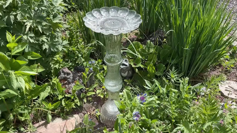 DIY bird bath made by gluing together glass vases and a decorative glass plate