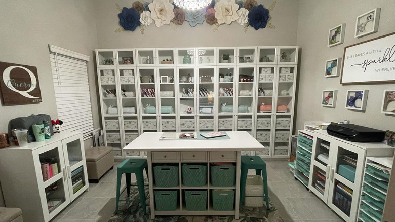 white bookcases in a decorated craft room
