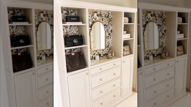 white billy bookcase dresser with handbags, mirror, cosmetics, and jewelry on it
