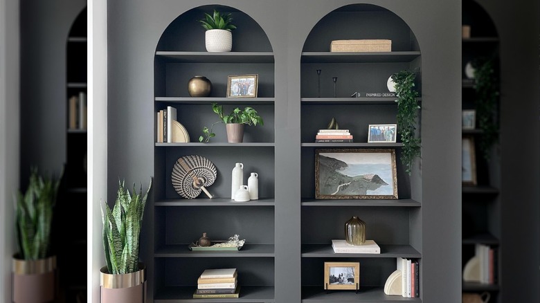 black BILLY bookcases with arches on top and family photos and decorations
