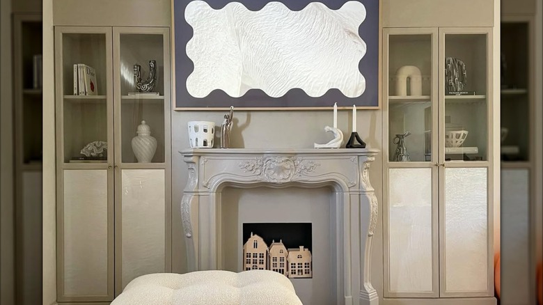 gray built-in bookcases framing fireplace mantel with decorations on top