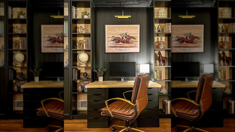 black bookcase next to desk holding decor