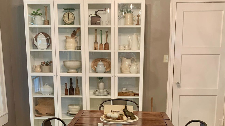 white IKEA billy bookcase in dining room holding china