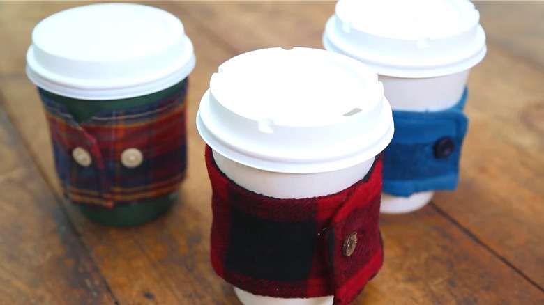 Cup cozies make of the cuffs of flannel shirts placed around disposable coffee cups
