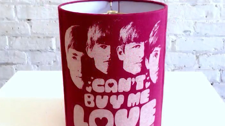 Lamp shade covered in a red and white "Can't But Me Love" Beatles band T-shirt
