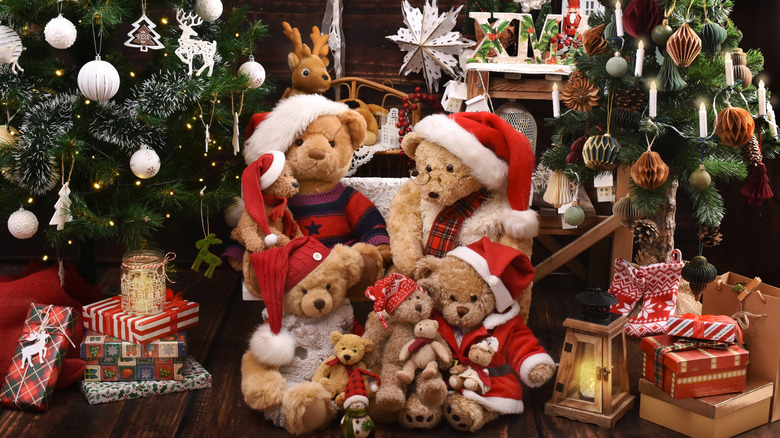 Christmas-themed bears next to a tree and presents