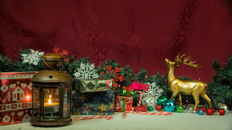 Holiday display with a golden reindeer and vintage-looking lantern