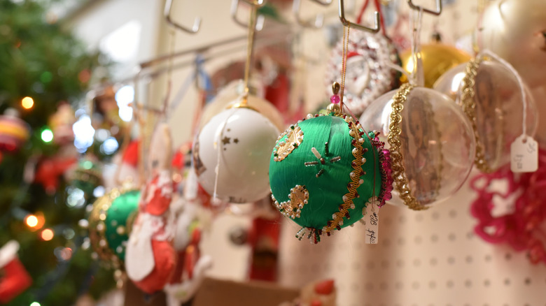 Fireplace decorated for Christmas with classic red accents, stockings, greenery, and warm lighting