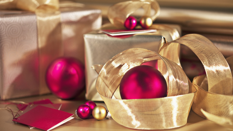 Gold ribbon next to ornaments and presents