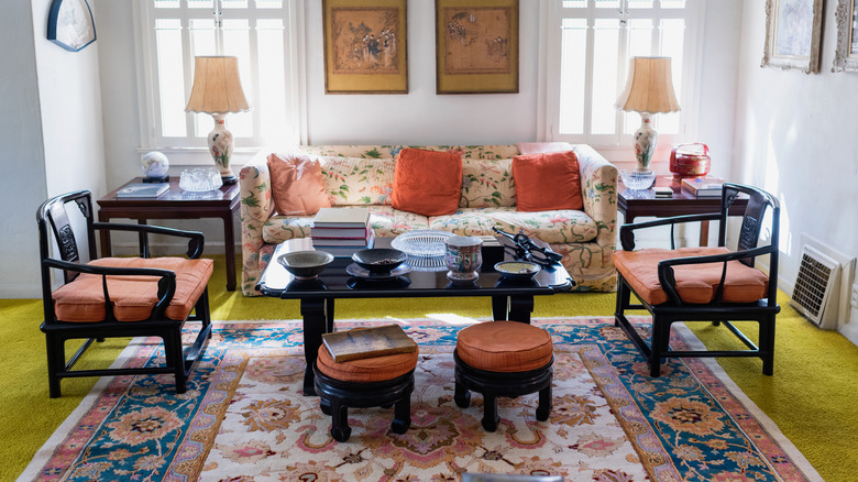 Maximalist room with floral antique rug